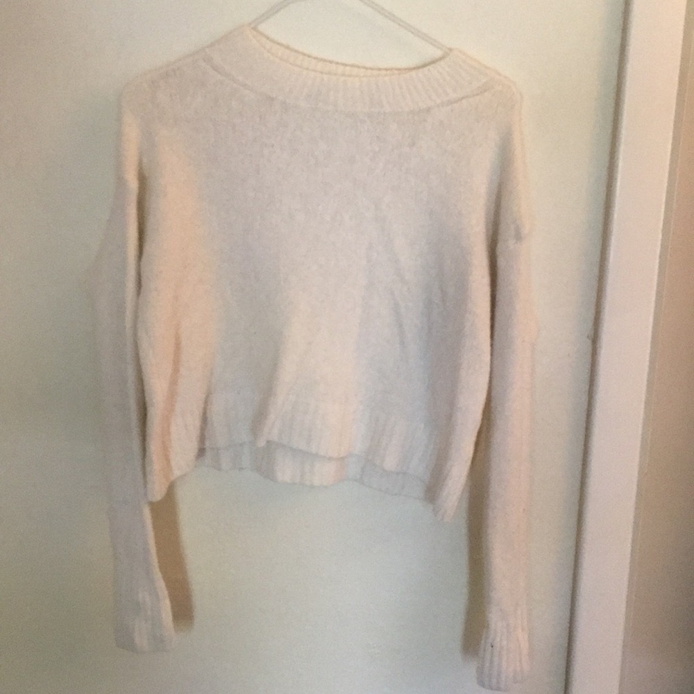 White, long sleeve, crop top sweater.